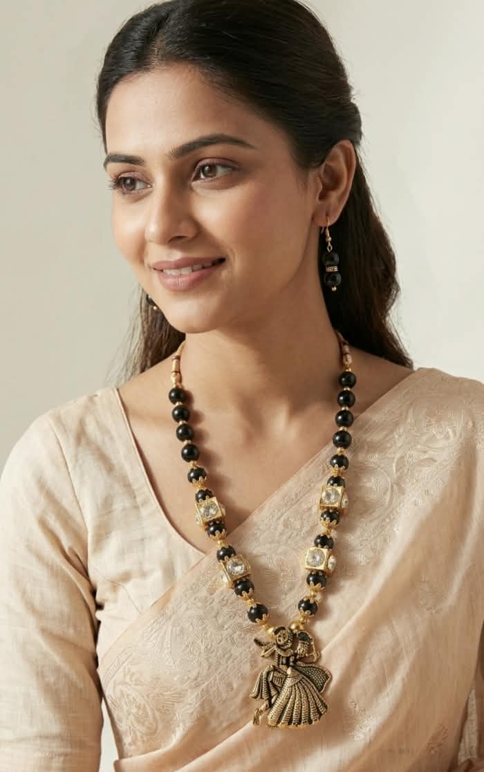 Antique Gold Plated Radha Krishna Pendant Long Necklace Set with Black Beads, Kundan Work & Matching Drop Earrings.